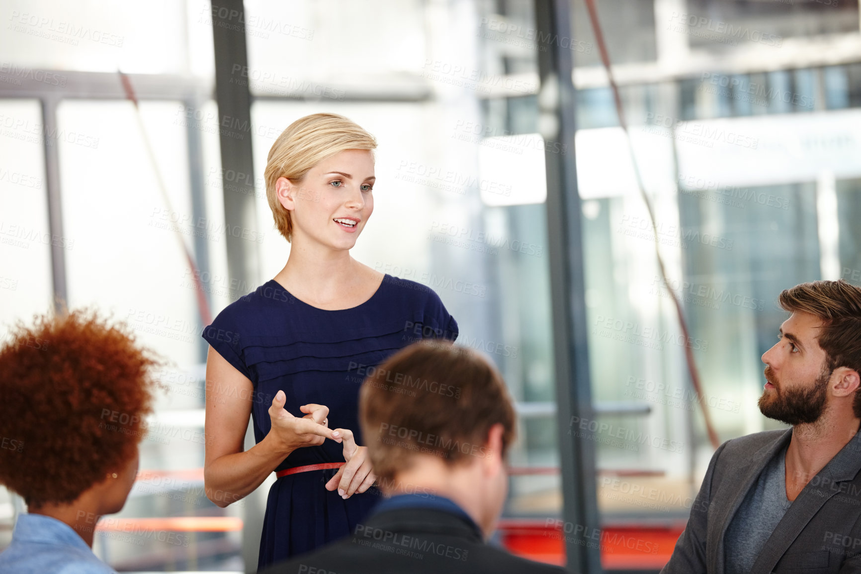 Buy stock photo Cropped shot of a female business professional sharing her ideas with her colleagues