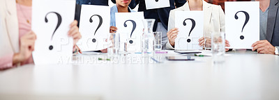 Buy stock photo Cropped shot of a group of businesspeople holding up cards with question marks on them