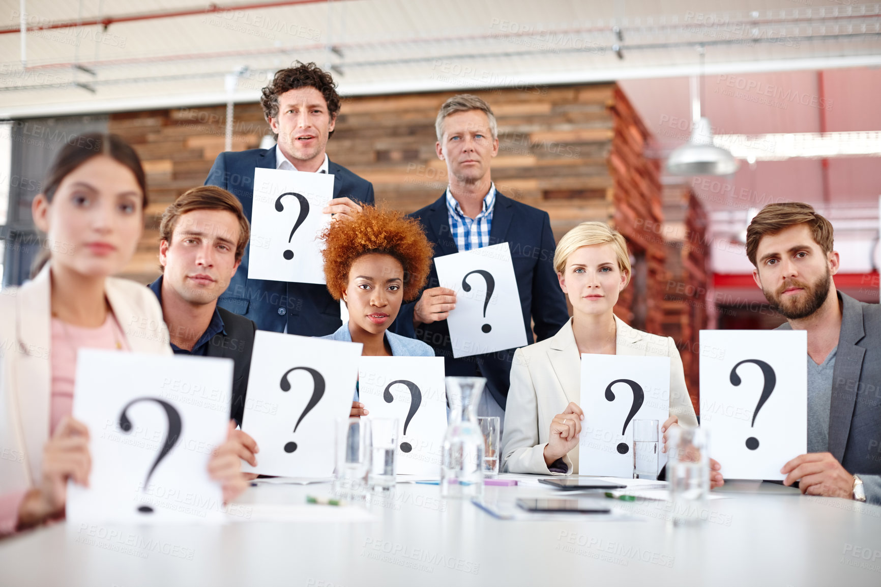 Buy stock photo Portrait of a group of businesspeople holding up cards with question marks on them