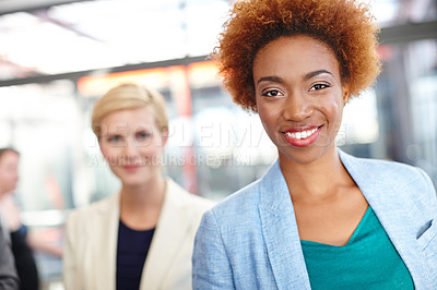 Buy stock photo Portrait of a trendy young business professional with a coworker standing in the background
