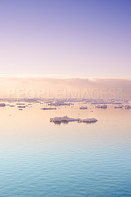 Buy stock photo Seascape with floating glaciers at dawn. Serene winter arctic landscape. Icebergs on calm sea horizon at sunset in Denmark. Colorful nature scene of midnight sun. Polar summer in Ilulissat Greenland