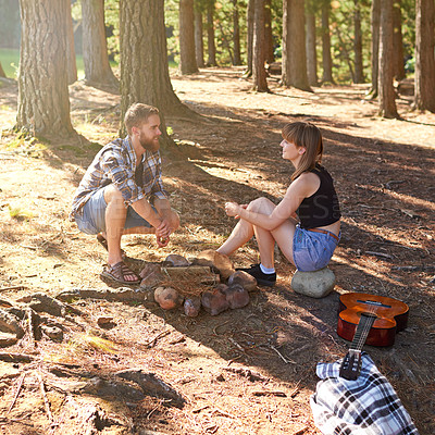 Buy stock photo Shot of a young couple on a camping trip together