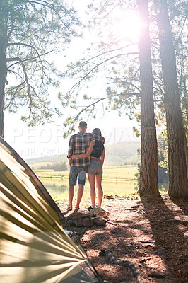 Buy stock photo Shot of a young couple camping by a lake