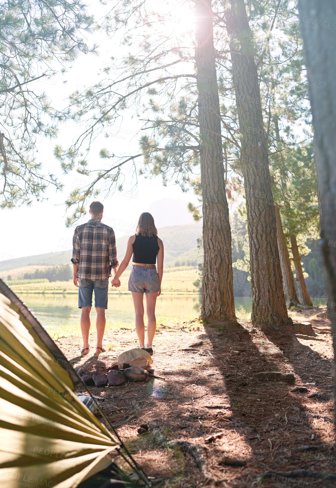 Buy stock photo Back, couple and holding hands for camping outdoor, summer vacation and romantic getaway of adventure. People, support and love with bonding together, trekking and holiday location for nature tourism