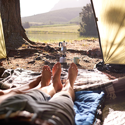 Buy stock photo Legs, couple and relax in tent for camping, summer vacation and romantic getaway with adventure. People, love and resting for bonding together, trekking holiday and camper location of nature tourism
