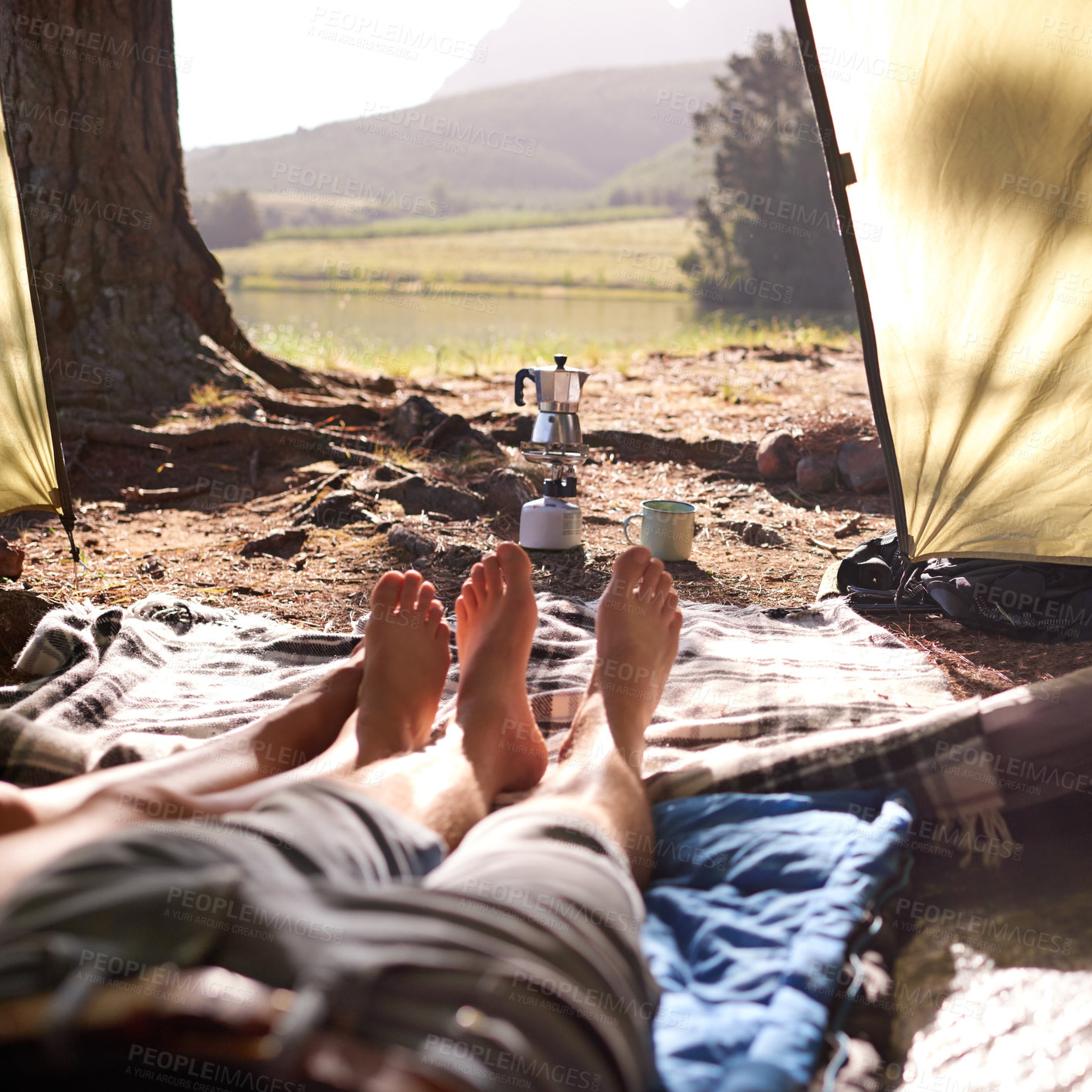 Buy stock photo Legs, couple and relax in tent for camping, summer vacation and romantic getaway with adventure. People, love and resting for bonding together, trekking holiday and camper location of nature tourism
