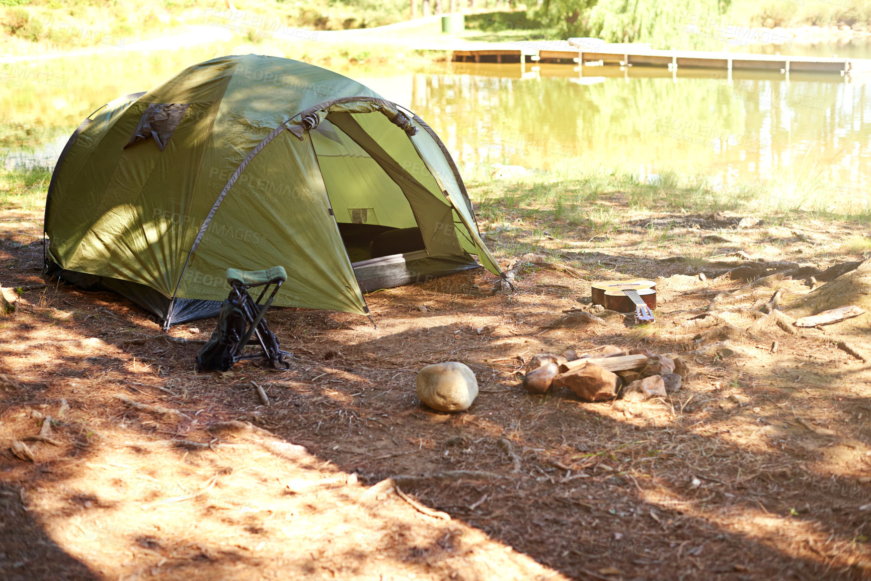 Buy stock photo Shot of an empty camping tent by the lakeside 