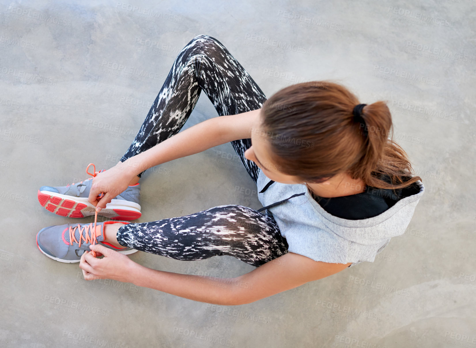 Buy stock photo Fitness, woman and tying shoes for exercise, workout and training for wellness. From above, female person and serious  with shoelaces for safety in sportswear for running, cardio and preparation