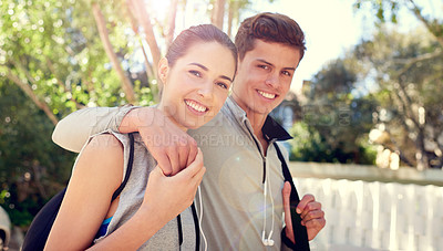 Buy stock photo Shot of a sporty young couple enjoying a walk in the outdoors