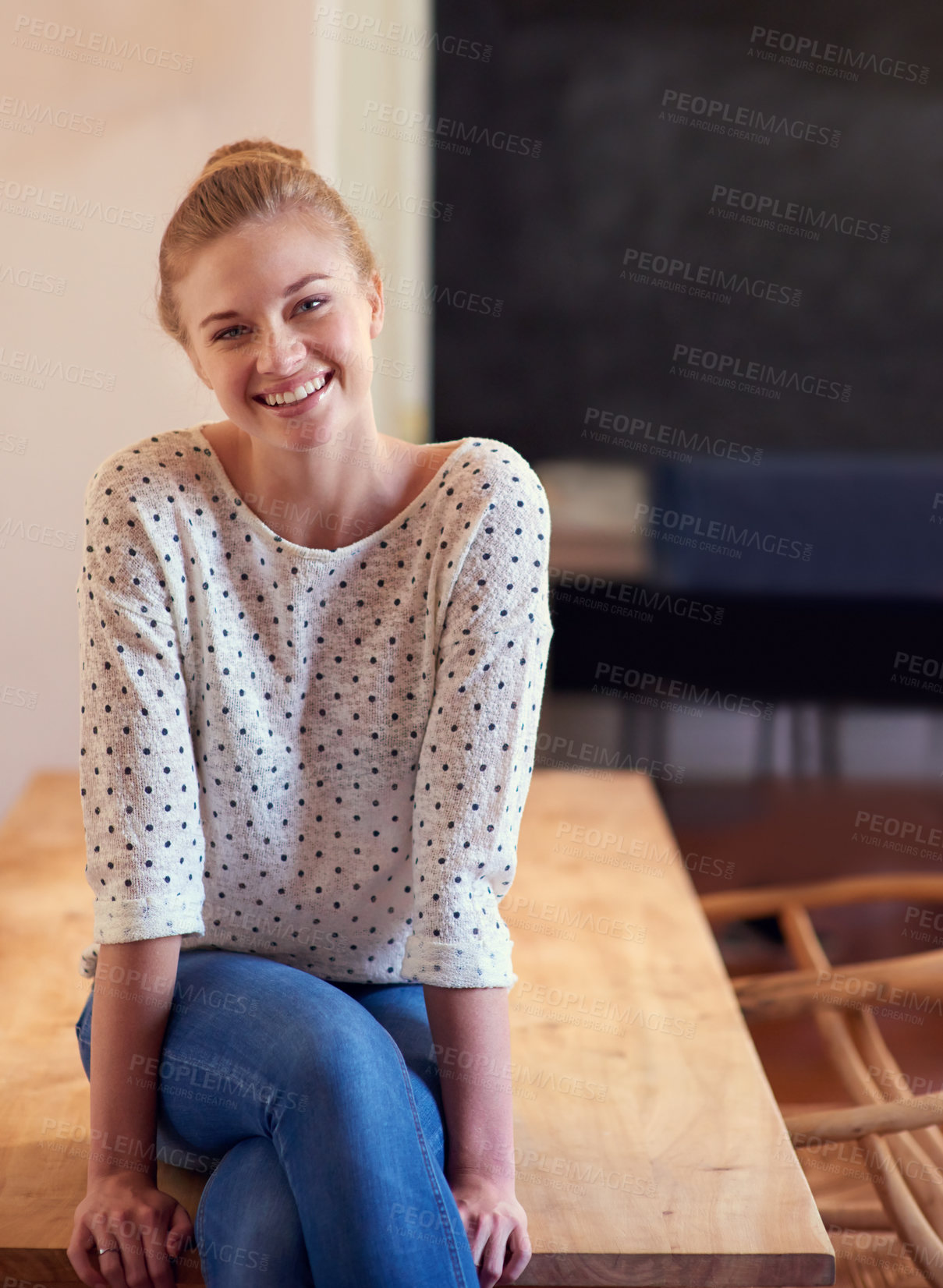 Buy stock photo Shot of a young woman sitting on the kitchen table