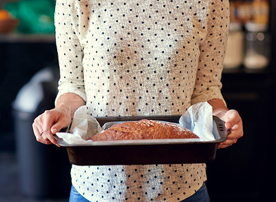 Buy stock photo Cropped shot of a woman holding a freshly baked bread loaf in a pan
