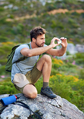 Buy stock photo Tourist, hiking and cellphone photography with mountain, view and pictures for travel blog and sightseeing. Man, backpacker and smartphone for hobby, adventure and relax with nature or summer holiday