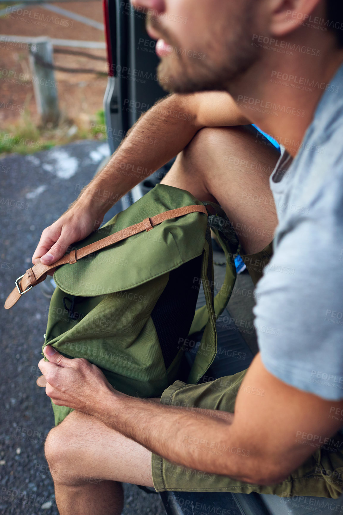 Buy stock photo Cropped shot of a man sitting in the back of his vehicle with a backpack