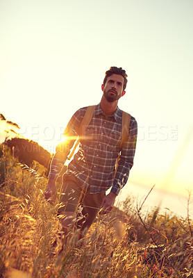 Buy stock photo Shot of a handsome young man enjoying a hike