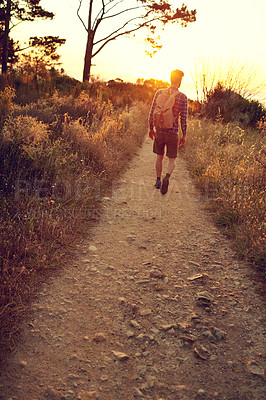 Buy stock photo Shot of a handsome young man enjoying a hike