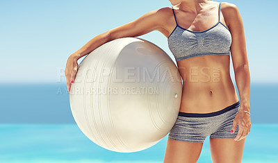 Buy stock photo Cropped shot of fit young woman holding an exercise ball