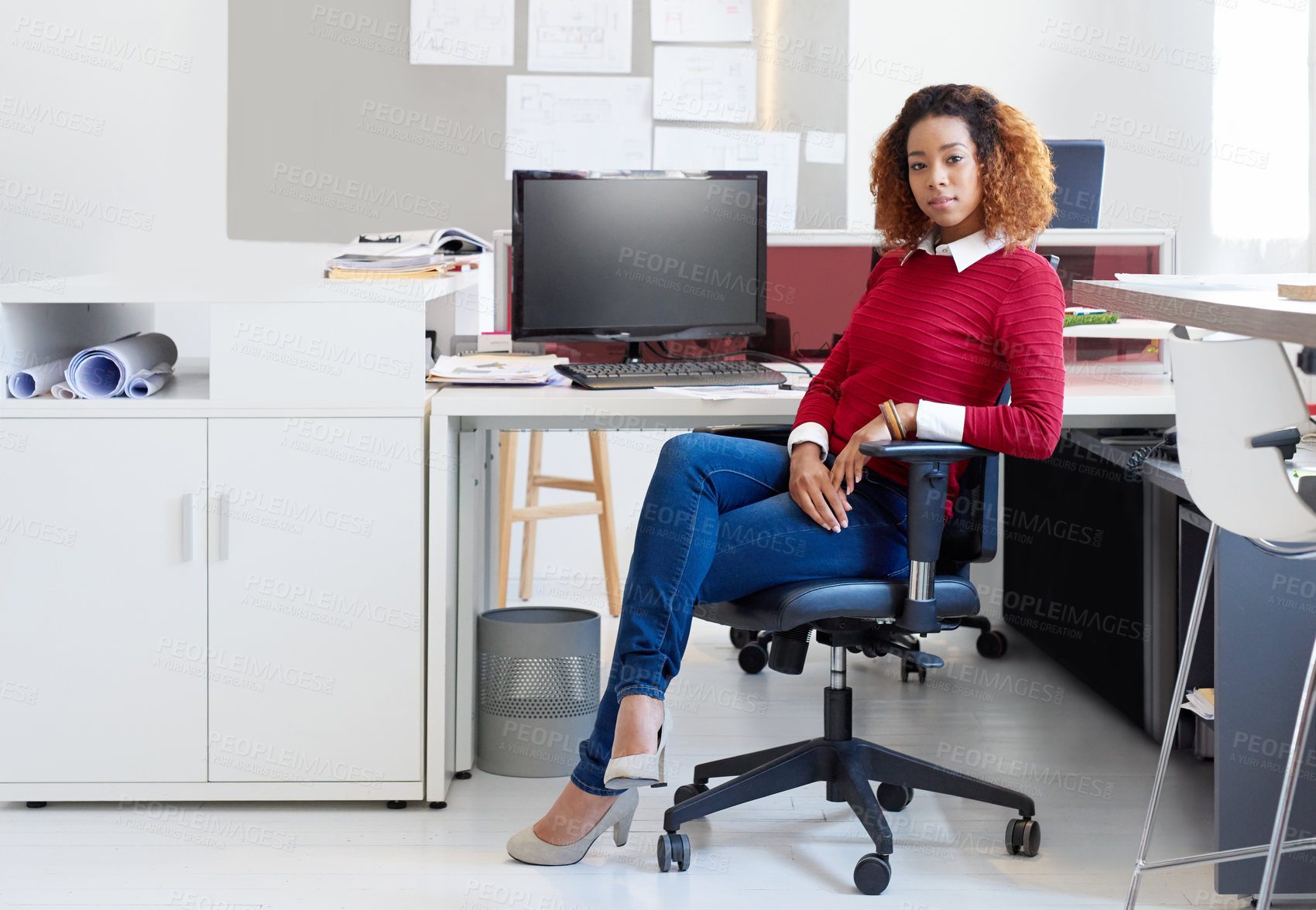 Buy stock photo Portrait of a young designer sitting at her workstation in an office