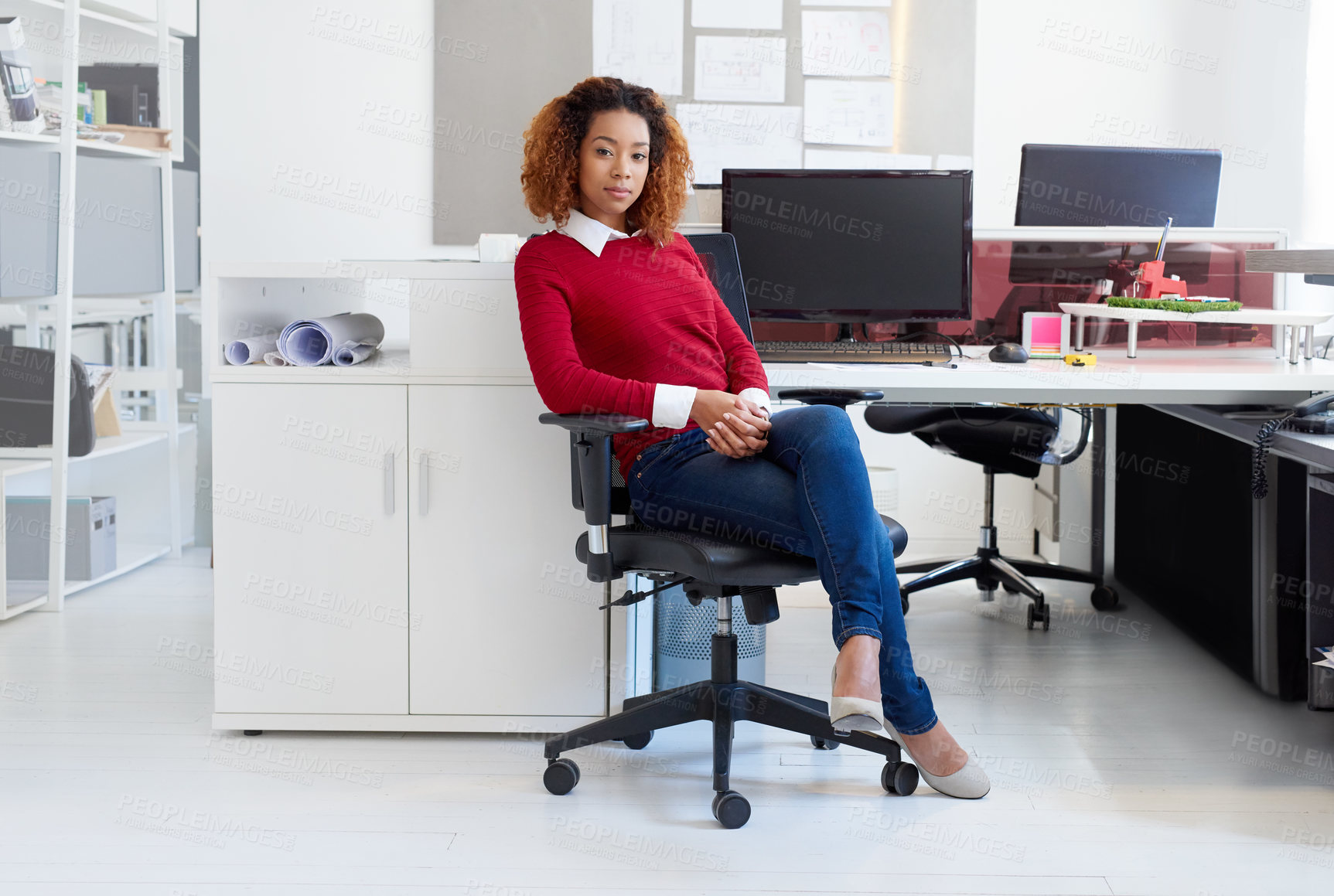 Buy stock photo Portrait of a young designer sitting at her workstation in an office