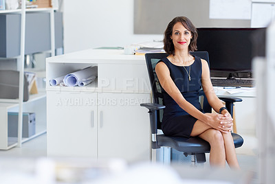 Buy stock photo Portrait of a young designer sitting at her workstation in an office