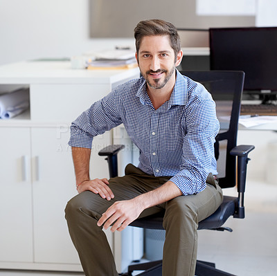 Buy stock photo Portrait of a young designer sitting at his workstation in an office