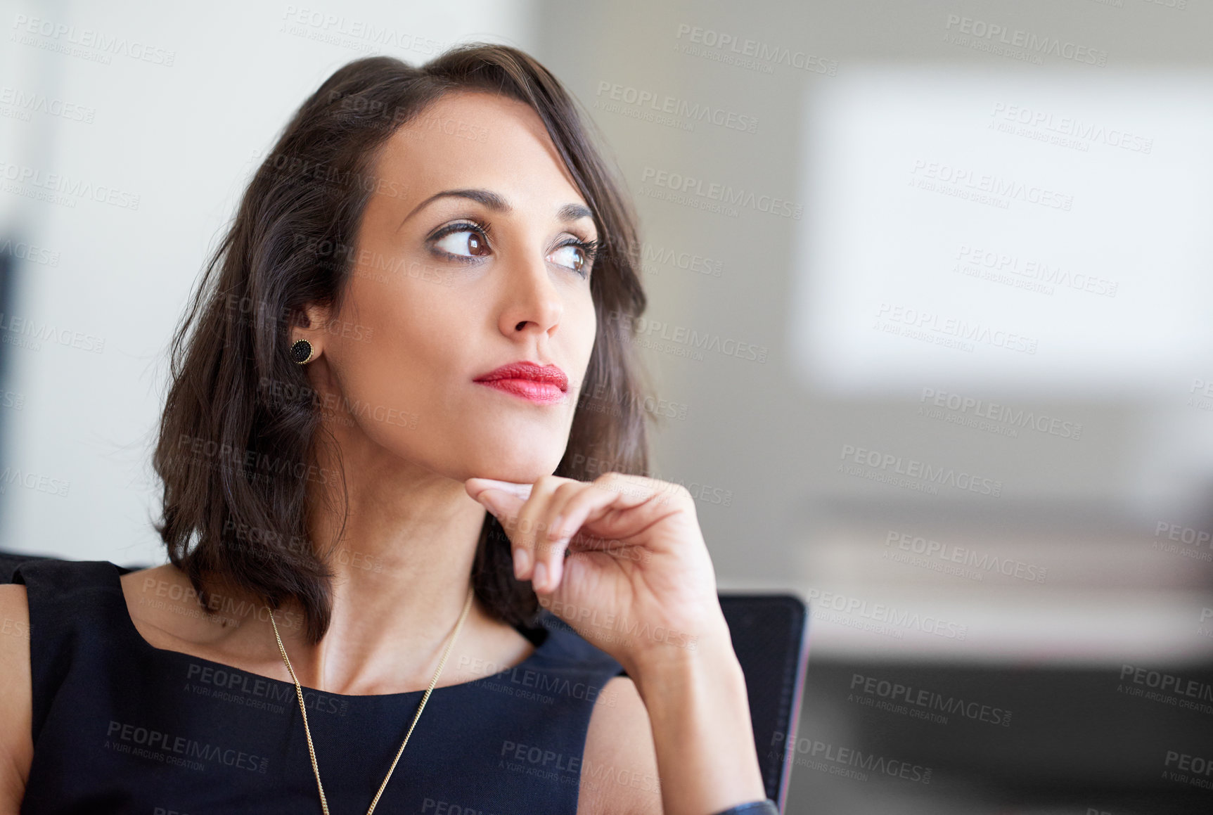 Buy stock photo Shot of an attractive businesswoman sitting in a chair in an office