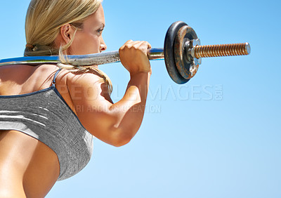 Buy stock photo Cropped shot of a young woman doing squats with a barbell outside