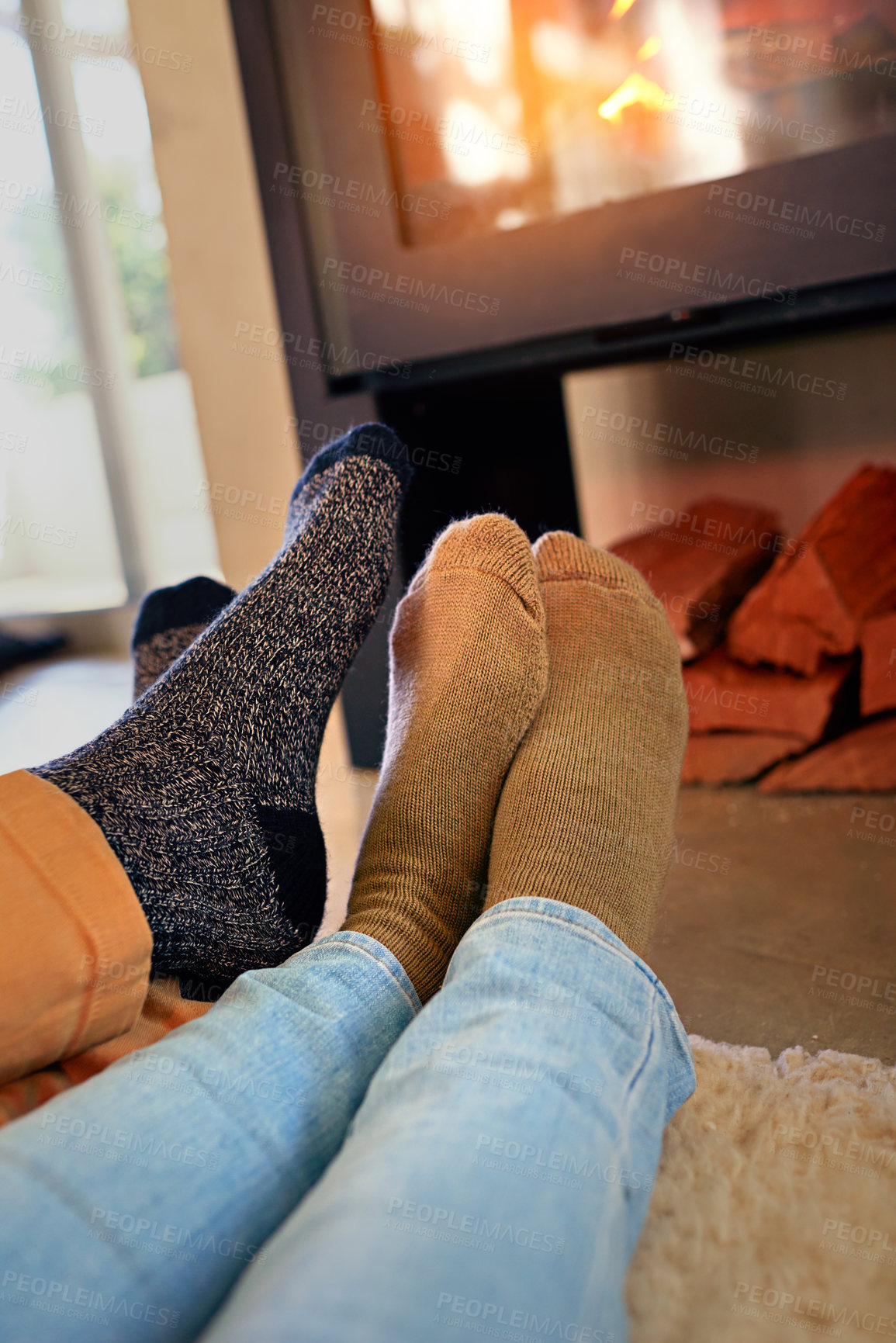 Buy stock photo Cropped shot of a couple sitting by the fireplace