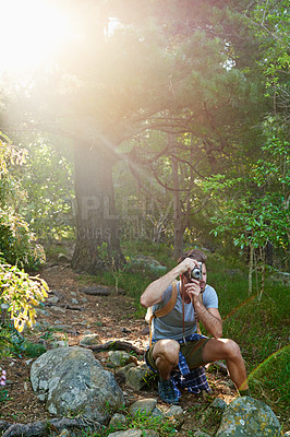 Buy stock photo Shot of a handsome man taking pictures of the scenery around him