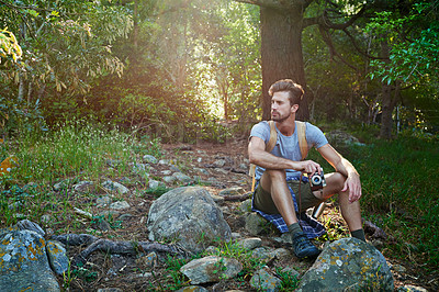 Buy stock photo Shot of a hiker holding his camera