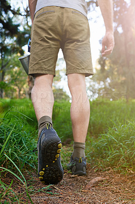 Buy stock photo Cropped shot of a hiker walking in the forest