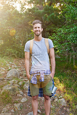 Buy stock photo Shot of a happy hiker standing with his hands in his pockets