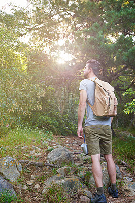 Buy stock photo Travel, hiking and man in forest with backpack outdoor for adventure, vacation or serious on holiday trip. Trekking, journey or person in woods for tourism, thinking or explore nature for sightseeing