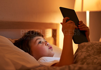 Buy stock photo Child, tablet and bed with night, reading and technology for social media or learning. Boy, bedroom and connectivity for knowledge, growth and elearning or internet surfing at home with touchscreen
