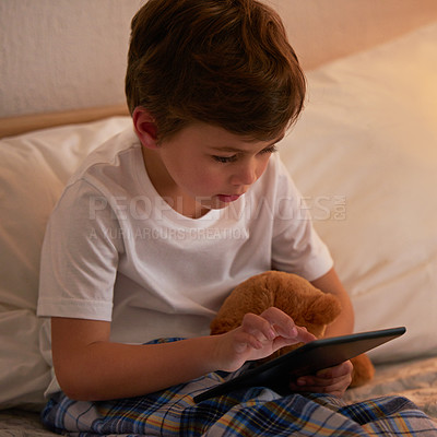 Buy stock photo Boy, child and tablet in bed at night for typing, reading or online game with app in family home. Kid, bedroom and digital touchscreen for movie, cartoon and streaming subscription to relax in house