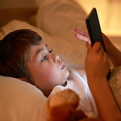 Buy stock photo Boy, tablet and bed with night, learning and relaxing for social media or learning. Child, bedroom and connectivity for knowledge, youth and elearning or internet surfing at home with touchscreen