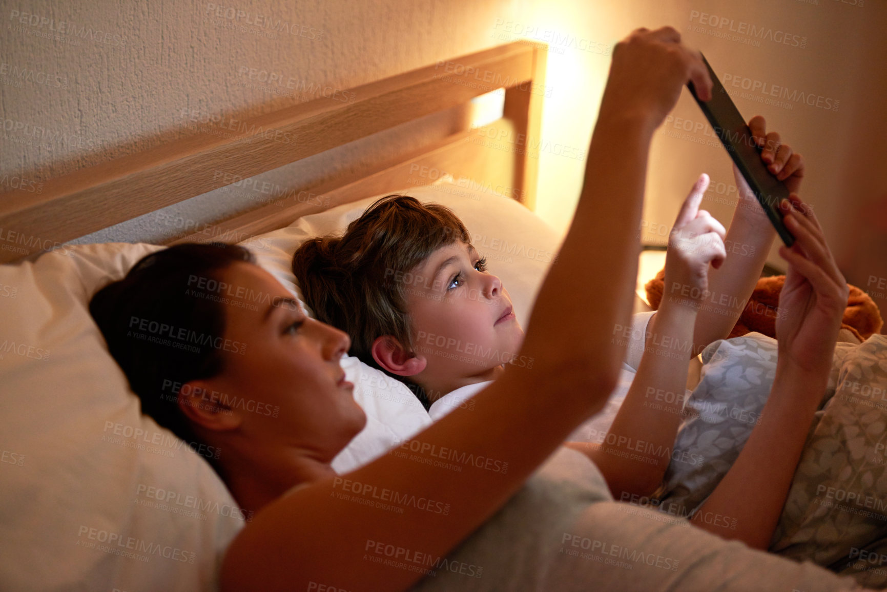 Buy stock photo Mom, boy and tablet in bedroom at night for care, bonding and watch movies together in family house. Mother, child and home on digital touchscreen for cartoon, film and streaming subscription in bed