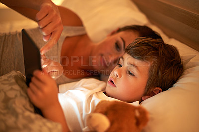 Buy stock photo Mother, boy and tablet in bed at night for care, bonding or to watch movies together in family house. Mom, child and digital touchscreen for cartoon. film and streaming subscription in home bedroom
