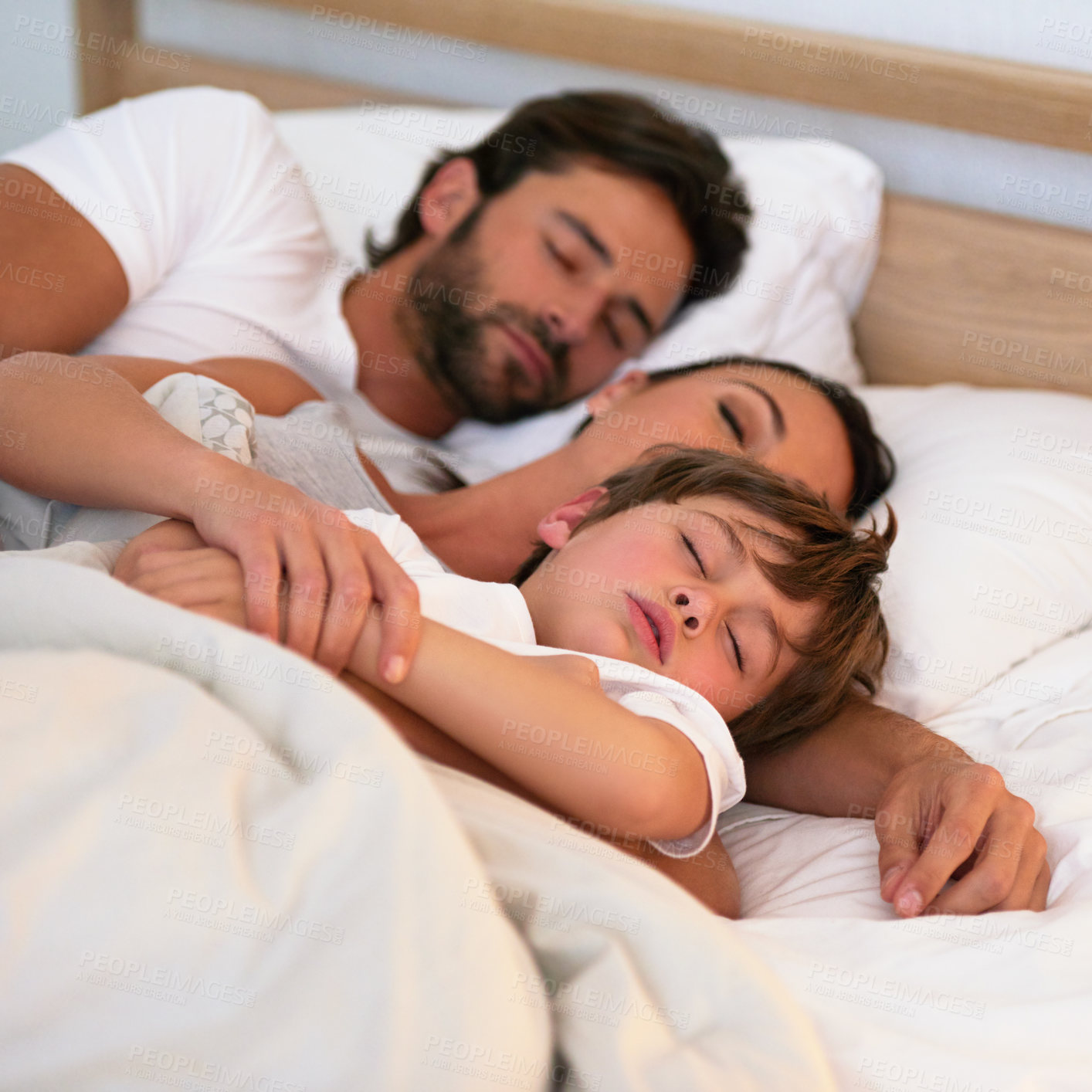 Buy stock photo Parents, boy and sleeping in bed, home and embrace for rest, peace and quiet in family home. Father, mother and child in bedroom with blanket for fatigue, burnout and exhausted in night at house