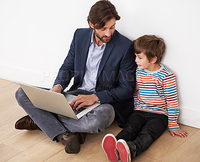Buy stock photo Father, son and relax in home with laptop for remote work with video streaming, online games and movies on floor. Family, parent and child with technology on ground for bonding, communication and fun