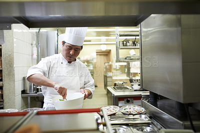 Buy stock photo Chef, cooking and Asian man in restaurant with bowl mixing ingredients for meal, dinner or lunch. Catering, career and male culinary worker preparing Chinese cuisine or food in fine dining diner.