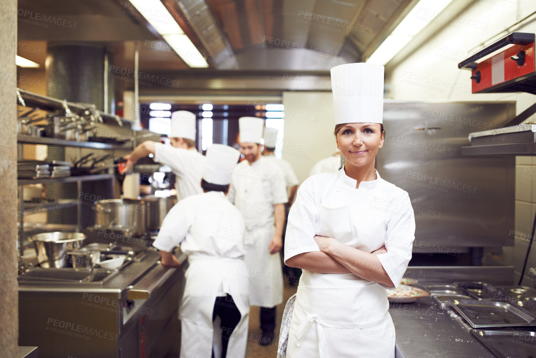 Buy stock photo Chef, arms crossed and portrait of woman in kitchen for hospitality service, cuisine and career. Fine dining, restaurant and face of cook in food industry for culinary, job and catering in Greece