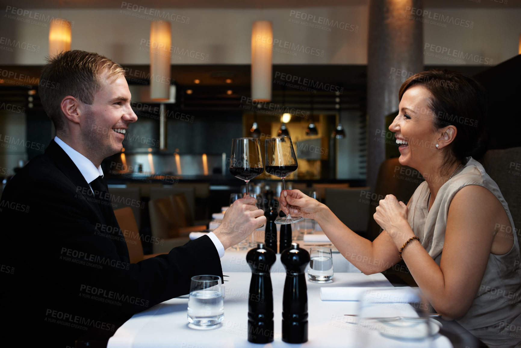 Buy stock photo Cropped shot of a couple having dinner in a restaurant