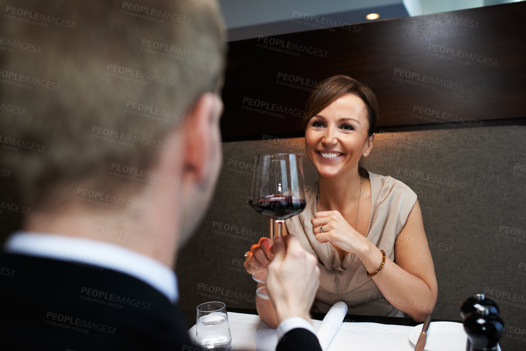 Buy stock photo Woman, dinner and wine glass for cheers at table, celebration and anniversary in restaurant. Happy, alcohol and smile for toast with man and wife, marriage and romantic for luxury date at night