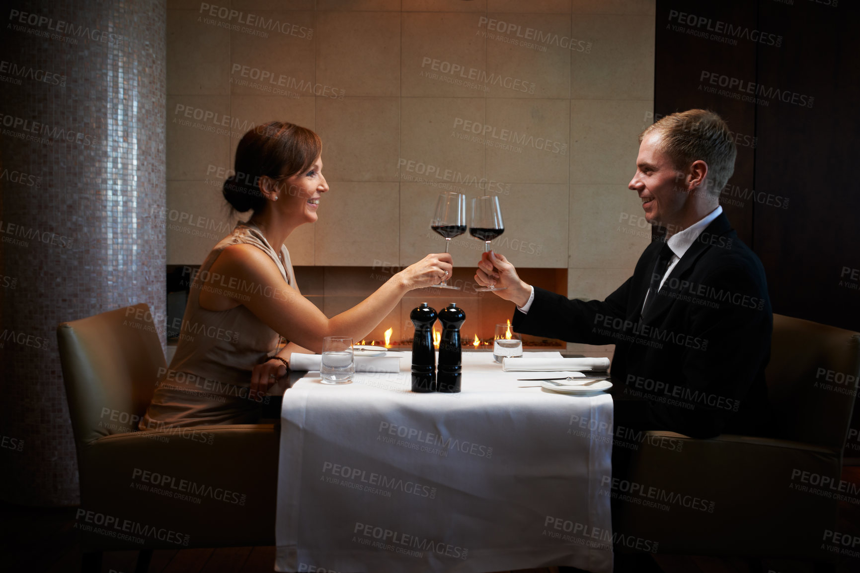 Buy stock photo Cropped shot of a couple having dinner in a restaurant