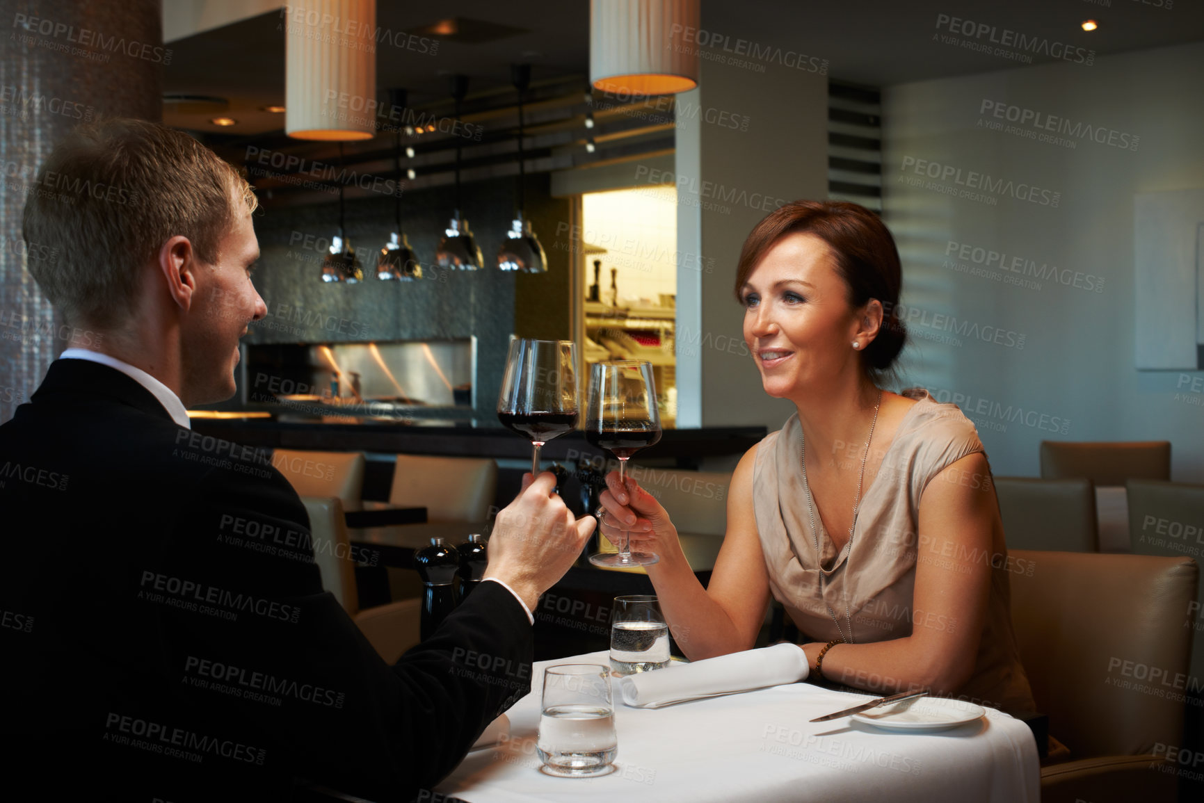 Buy stock photo Couple, toast and date with wine, excited or romantic for connection, relationship and bonding as partner. Female person, smile and dinner with man for drink, celebration or anniversary at restaurant