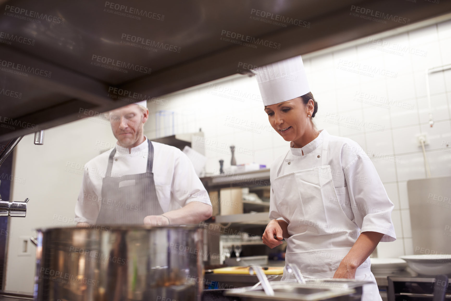 Buy stock photo Cooking, chef and trainee in kitchen with pot for food preparation, fine dinning and gourmet cuisine. Professional cook, people and catering in restaurant with ingredients for luxury meal or lunch