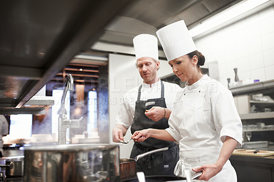 Buy stock photo Chef, teamwork and cooking in kitchen at stove or preparation of food for fine dining, cuisine or hospitality. Man, woman and service as restaurant career or recipe for dinner rush, meal or nutrition