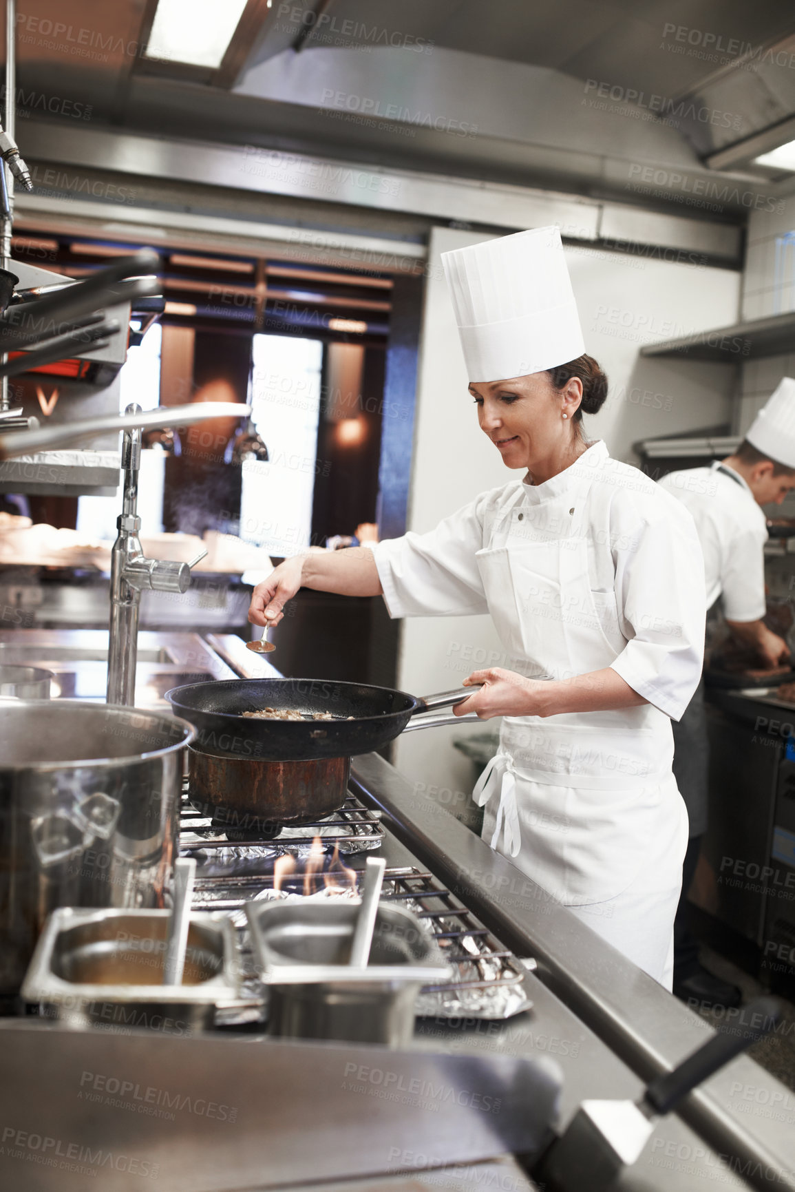 Buy stock photo Chef, woman and frying pan with sauce in restaurant kitchen, catering service and prepare food for fine dining. Professional, cooking and female saucier or person with meat meal for hospitality.
