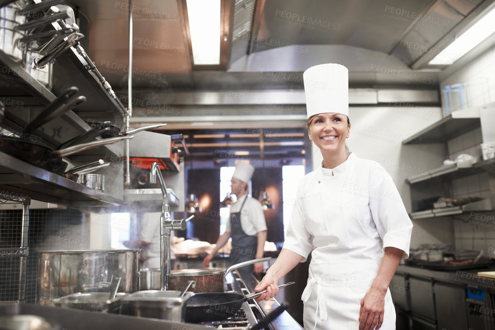 Buy stock photo Chef, woman and happy with frying pan in kitchen, catering service and prepare food for fine dining in restaurant. Professional, cooking and female person saute, cook and thinking about hospitality.