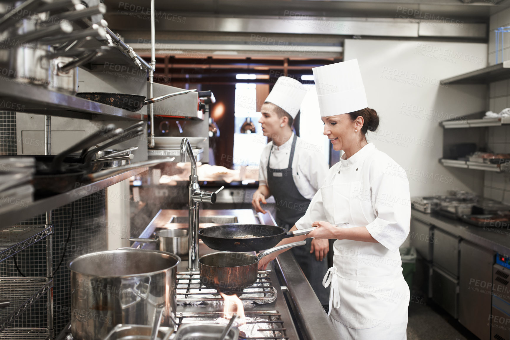 Buy stock photo Chef, woman and frying pan in kitchen for catering service, fine dining or prepare dish. Hospitality, employee and female person with meat for cooking meal, food industry or dinner in restaurant